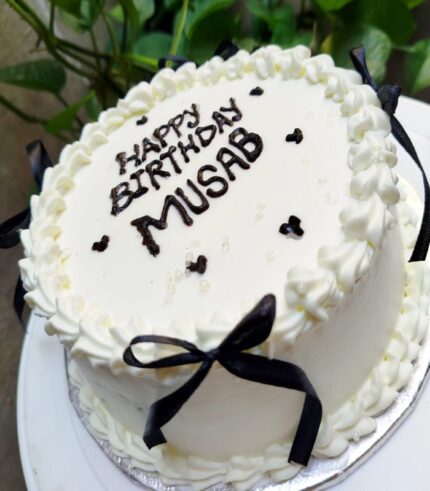 Royal White Birthday Cake with silky buttercream and black ribbon decoration – perfect for birthdays and celebrations